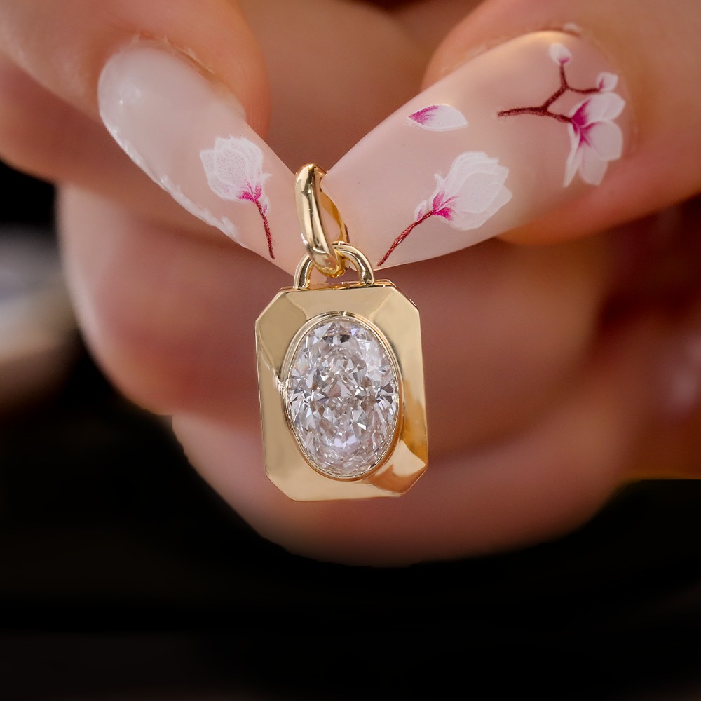 1.1ct oval diamond bezel-set 18K gold pendant