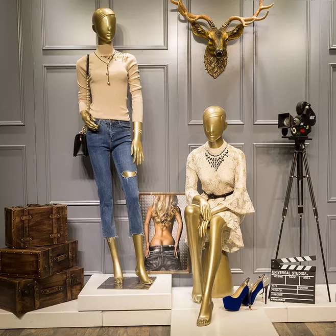 Bronze colored female mannequins sitting or standing posture