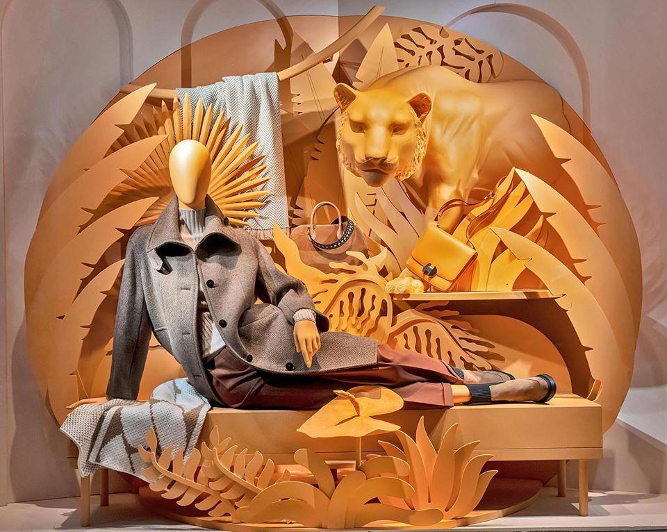Lion statue decoration window display design with African savanna background