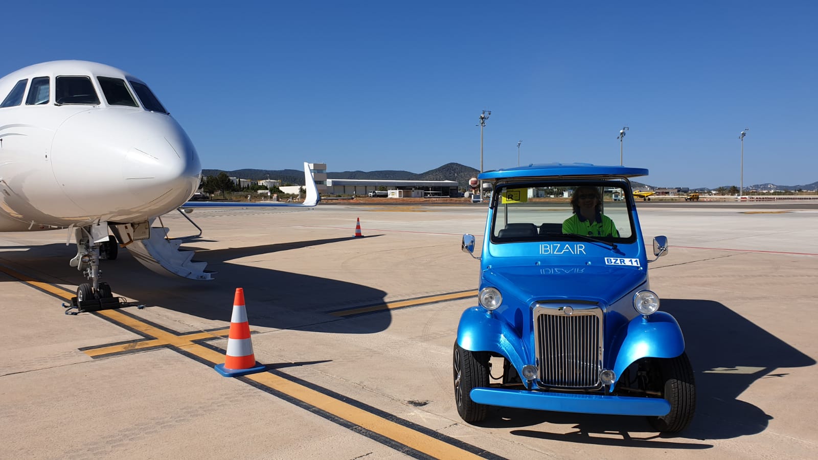 The electric sightseeing cart  is used in a Spainish airport.