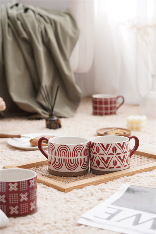 A coarse earthenware red striped cup