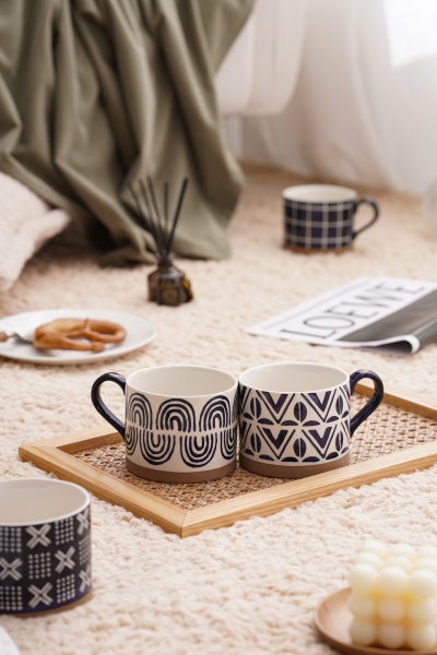 A blue striped cup made of coarse ceramic material