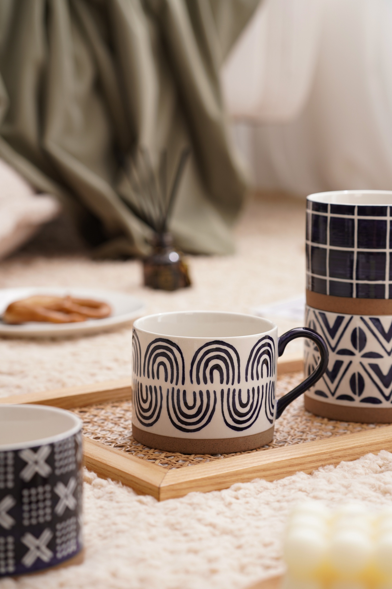 A blue striped cup made of coarse ceramic material