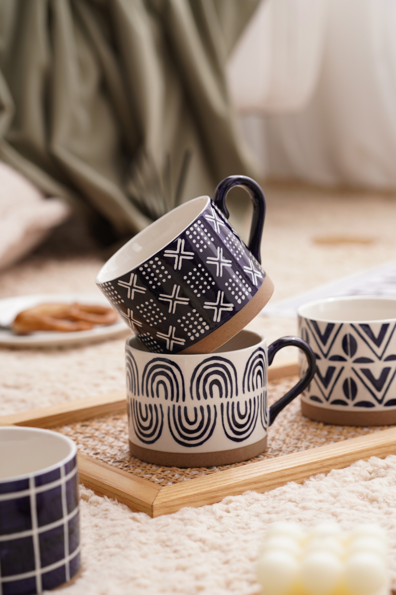 A blue striped cup made of coarse ceramic material