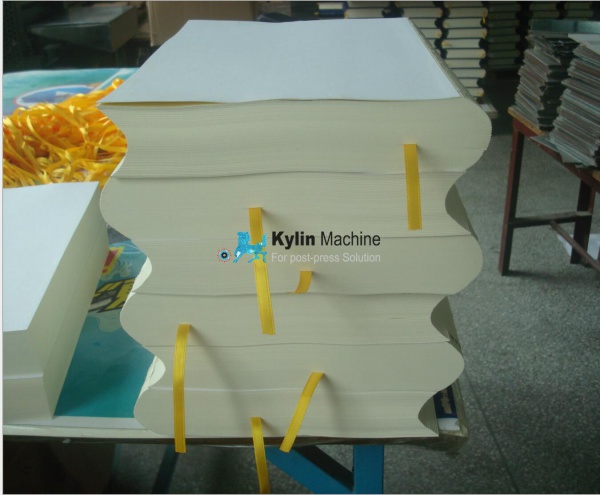 Book spine rounding and backing machine
