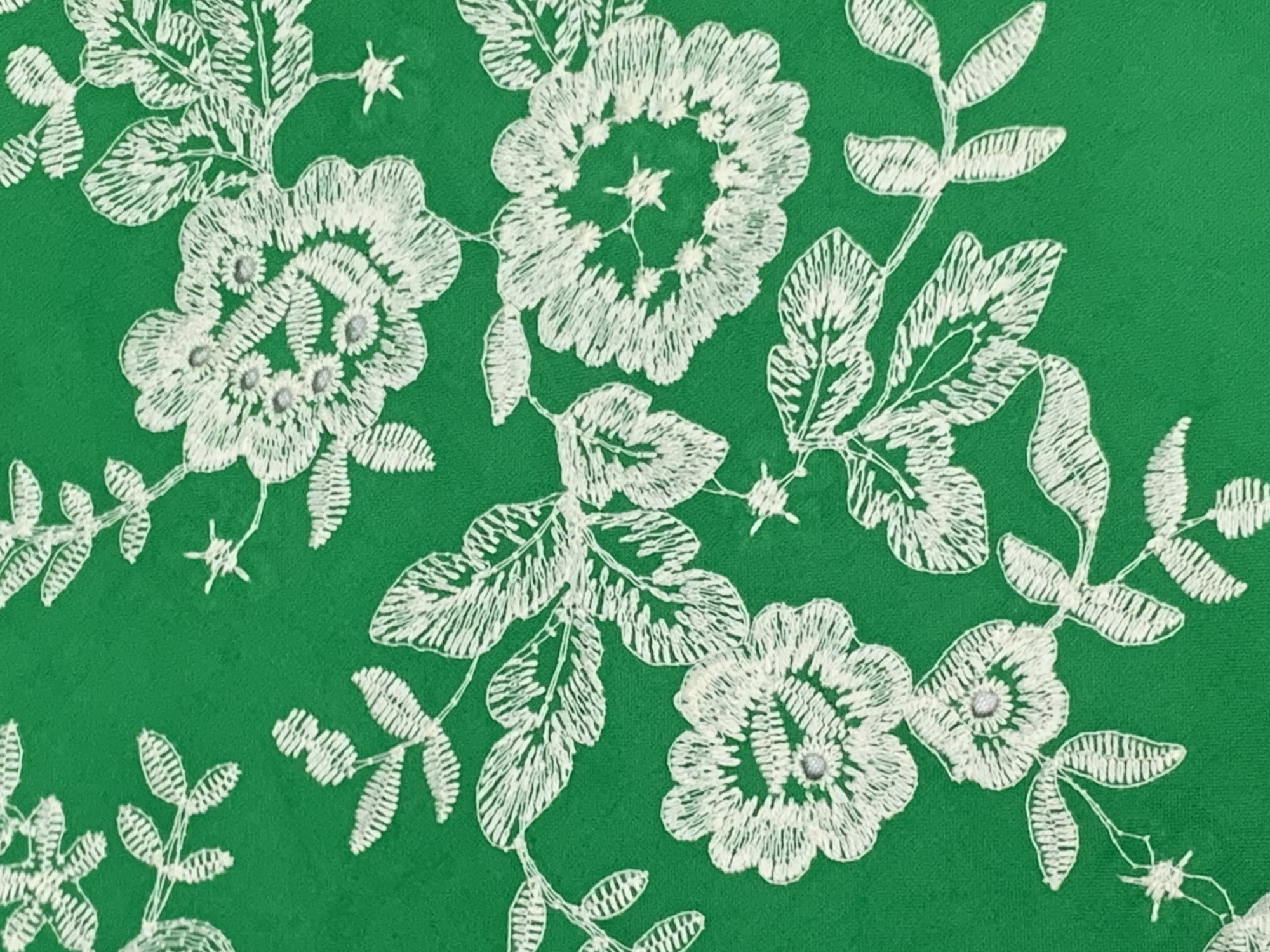 Green cotton fabric with white floral embroidery