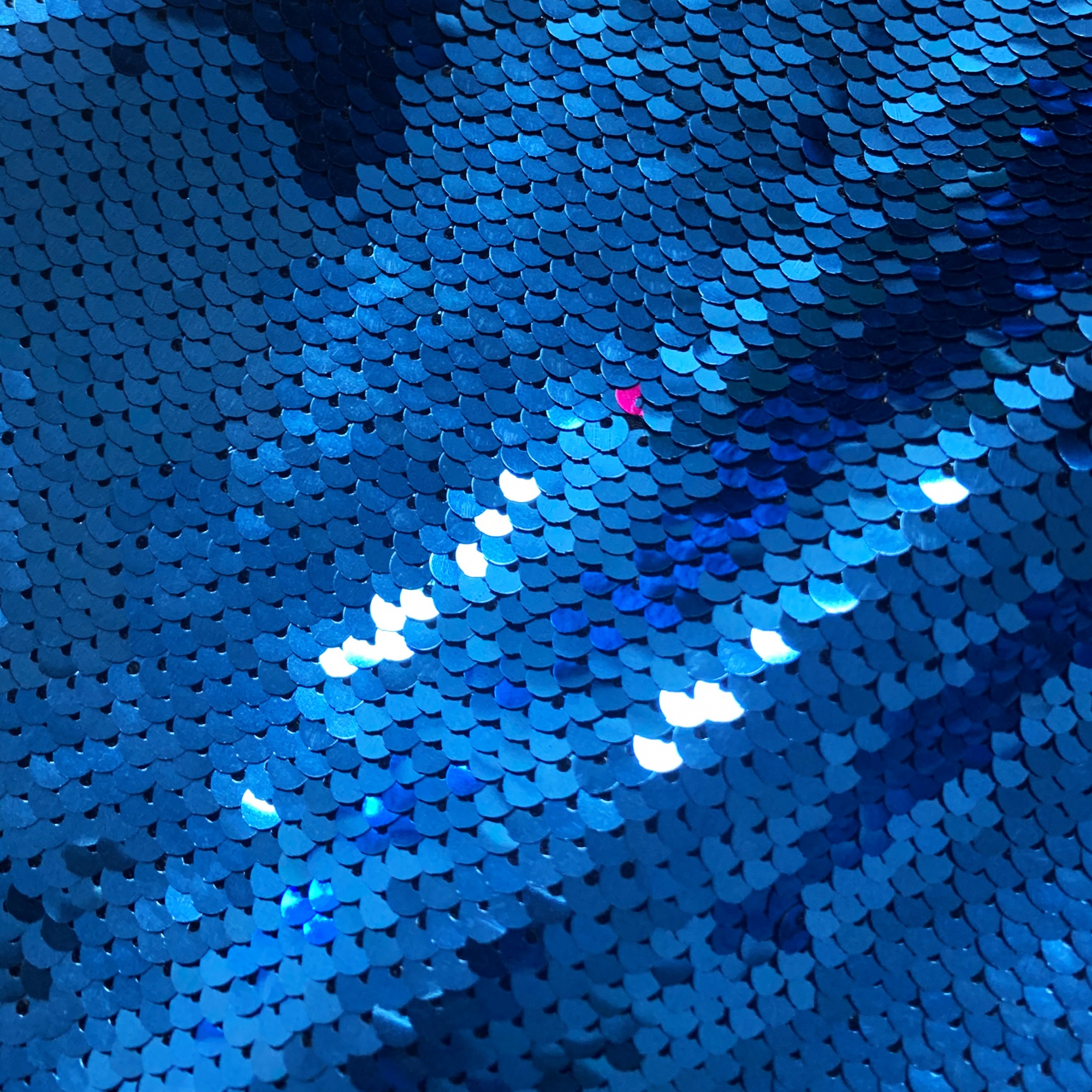Blue sequined embroidered fabric, suitable for making tops, skirts, home textiles, wedding dresses, and stage costumes. Vibrant color.