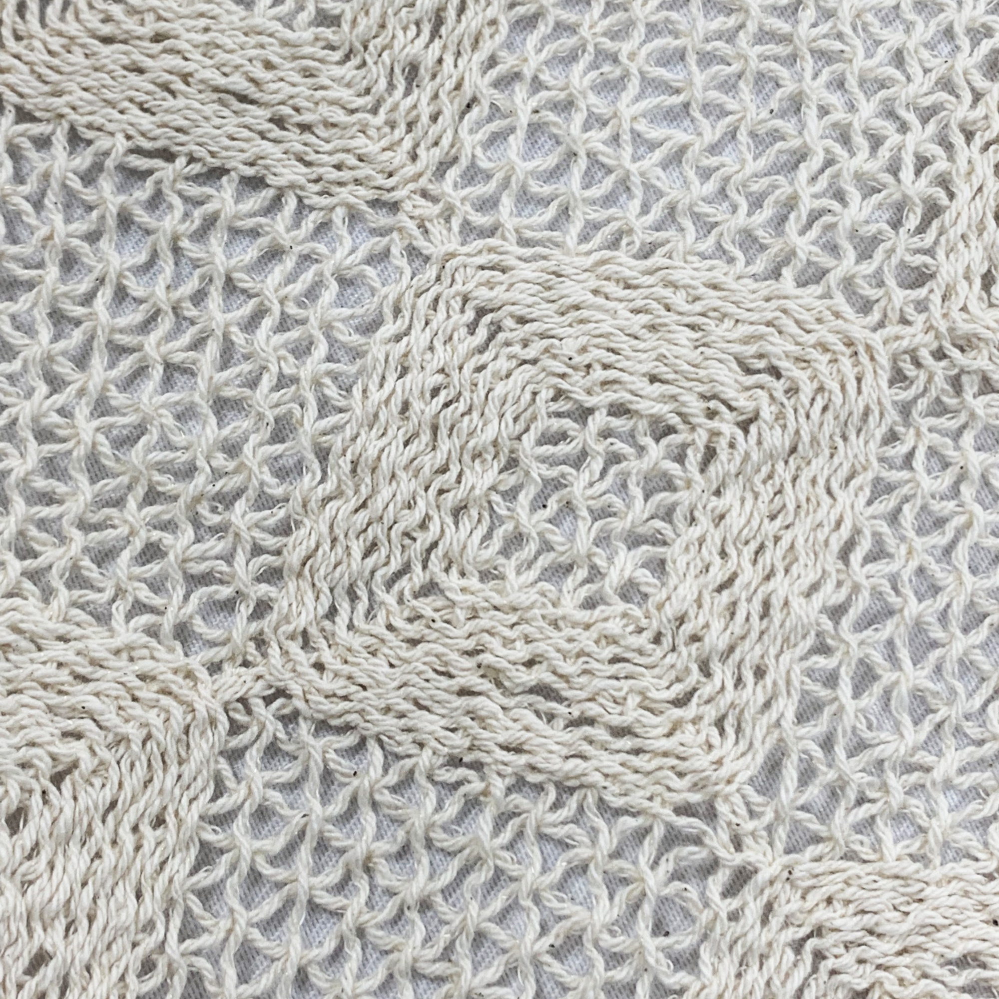 Beige rope-woven embroidered fabric.